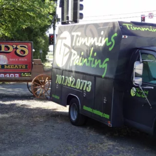 Timmins Painting truck infront of Bud's Custom Meats sign