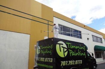 Timmins Painting employee on truck to paint building