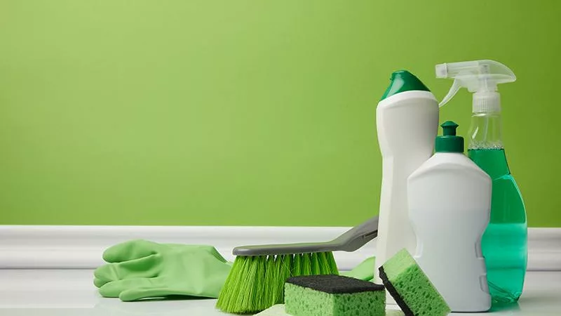 cleaning supplies and bright green painted wall