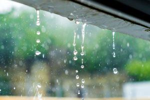 Rain weathering the paint on the exterior of a home