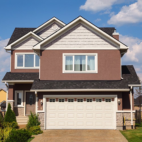 The exterior of a home freshly painted a warm earthy brown, Dunn-Edwards Art and Craft paint home home exterior