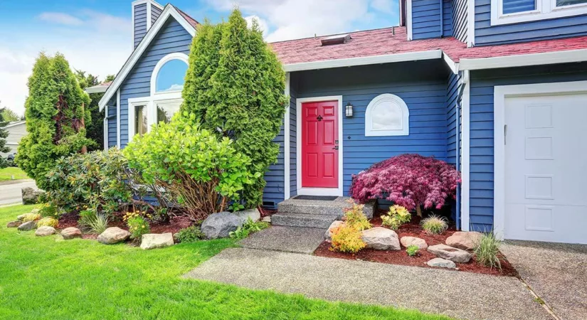 front of freshly painted blue house with red door