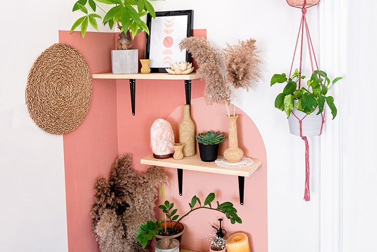 A color block painted wall in the corner of a trendy room with with boho decor