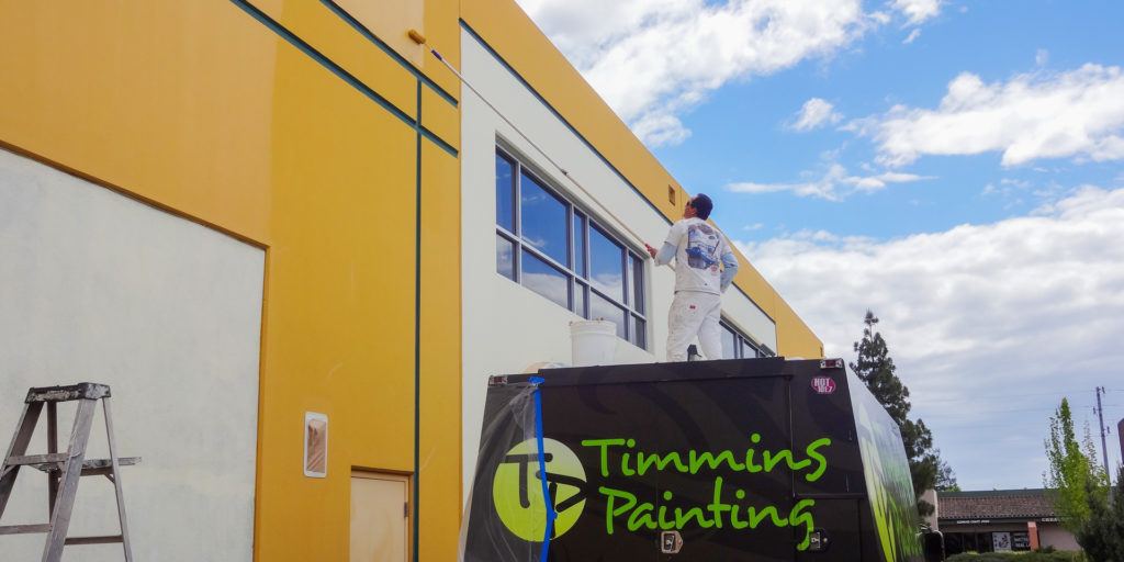 timmins professional painters painting exterior of a santa rosa business with elastomeric coating