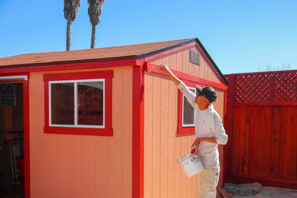 Timmins professional painter painting the trim on a shed