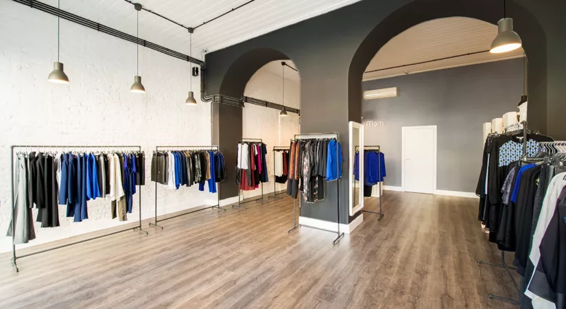 interior of high-end fashion boutique freshly painted to make white, grey, and black business branding