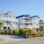 Coastal homes lined up on a street, showing the concept of how coastal weather affects exterior paint