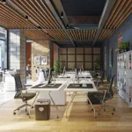 The interior of a bright commercial office building, with hardwood floors, charcoal walls, and large windows